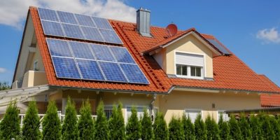 House with solar photovoltaic panels on roof