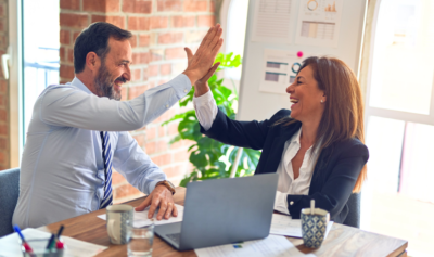 Green business colleagues high fiving